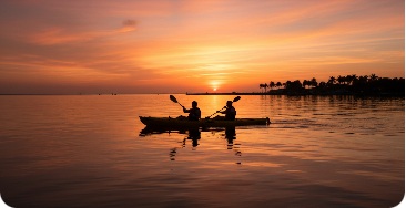 Kayakers silhouetted at sunset in South Florida